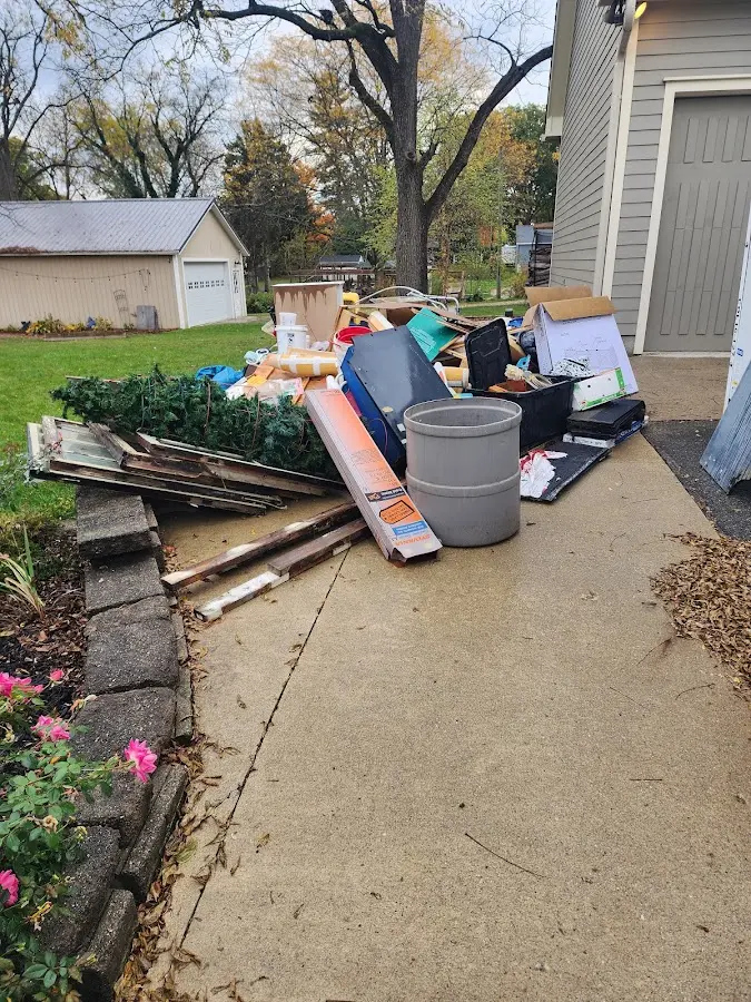 Dumpster being loaded with debris for 12 Yard Dumpster Rental in Ocean View